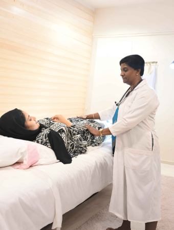 Gynaecologist examining an expectant mother at Smita Memorial Hospital